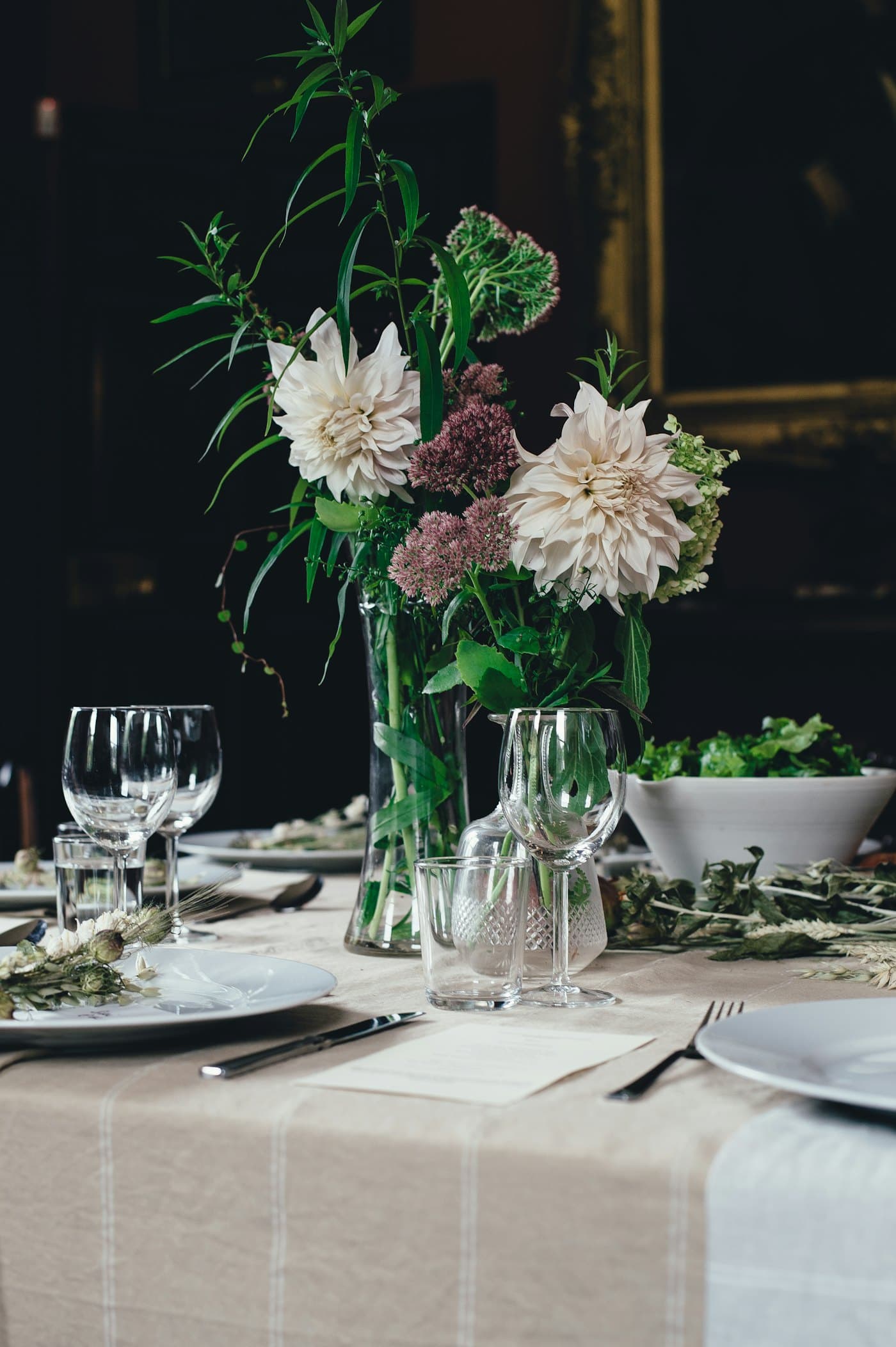 An elegant candlelit garden tablescape set with white roses and brass